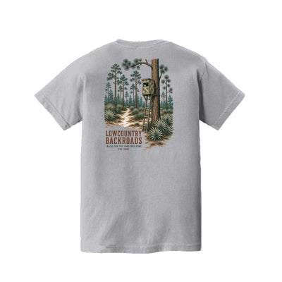 Pine Woods Watch Lowcountry Backroads youth T-shirt graphic featuring a camouflaged tree stand, pine forest, palmettos and woodland trail