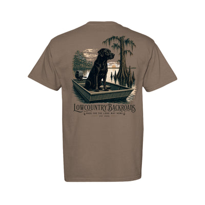 Steady at First Light graphic with a black Labrador sitting in a jon boat among moss-draped cypress trees at sunrise.